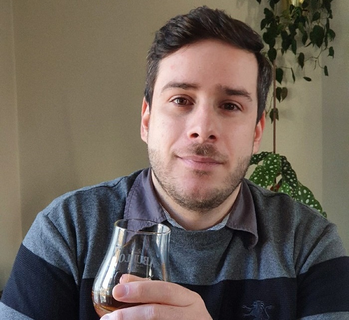 Nelson Carvalho Reis holding a glass of whiskey